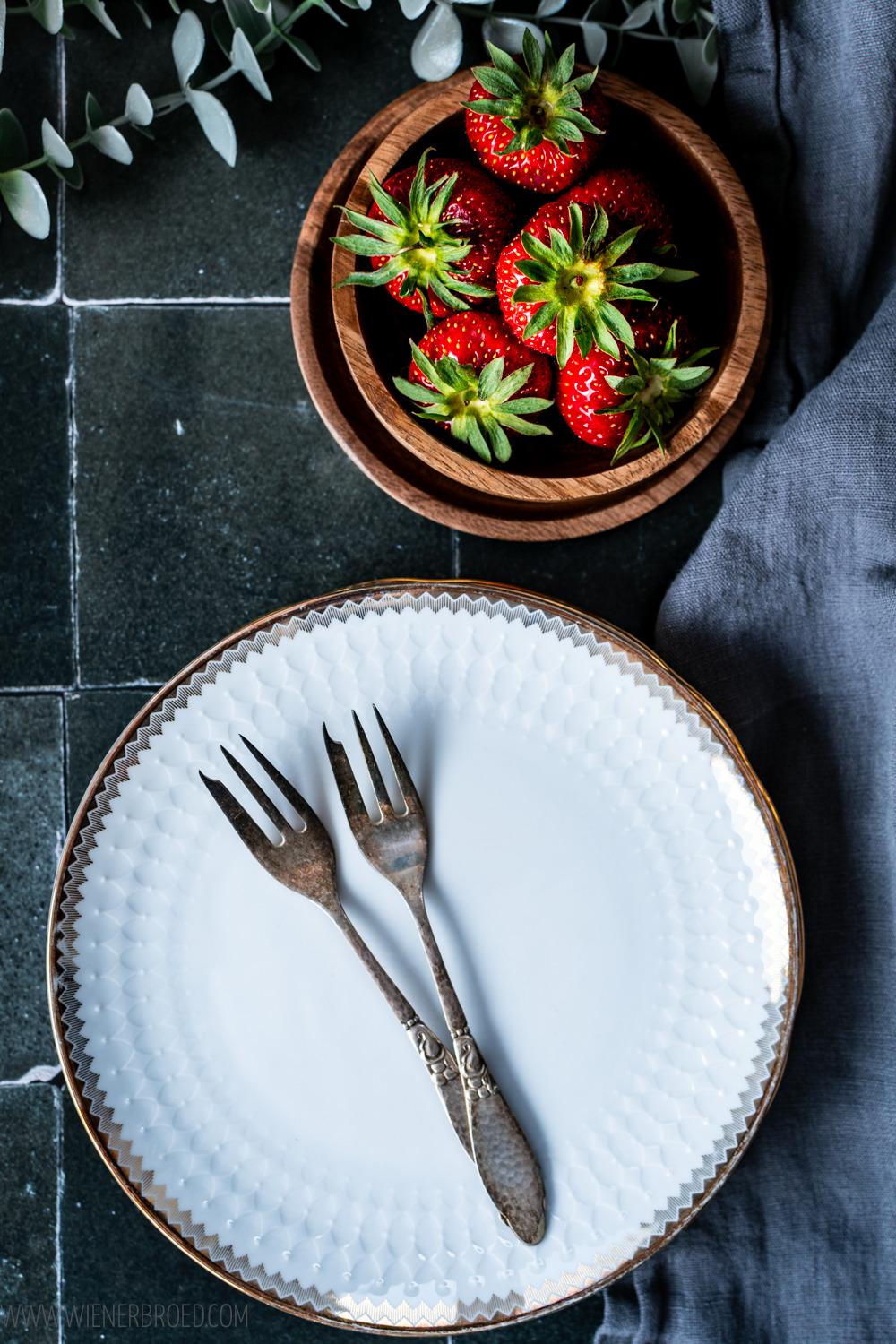 Erdbeeren und alte Teller und alte Kuchengabeln